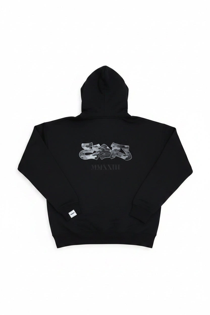 Black hoodie with white graphics and text on a wooden surface