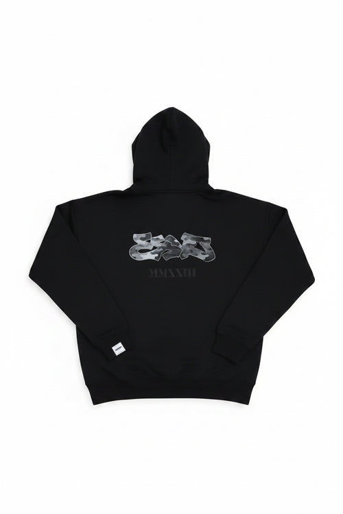 Black hoodie with white graphics and text on a wooden surface